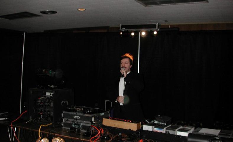 Disc Jockey Don Tilford Standing by Full Table of Audio And Lighting Equipment & Music